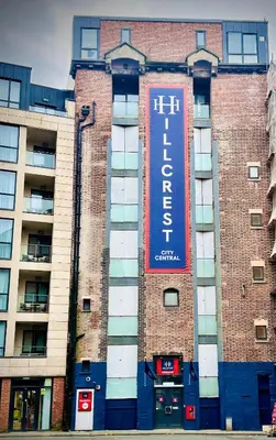 a building with a sign on the side of it at Hillcrest Liverpool City Central in Liverpool
