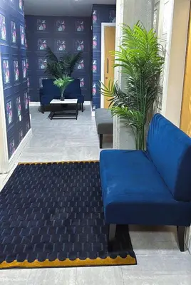 a blue couch in a lobby with plants at Hillcrest Liverpool City Central in Liverpool