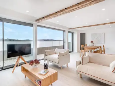 a living room with two couches and a tv at Beach Haven in Arnside