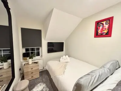a bedroom with a bed and a television in a room at Lethbridge Villa 49 Apartment 3 Super Fibre WiFi, Free parking in Southport