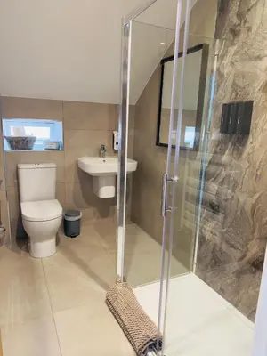a bathroom with a shower and a toilet and a sink at Lethbridge Villa 49 Apartment 3 Super Fibre WiFi, Free parking in Southport