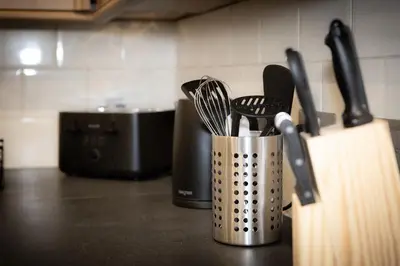 a metal container with utensils on a kitchen counter at Lethbridge Villa 49 Apartment 2 Super Fibre WiFi, free parking in Southport
