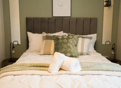 a large bed with pillows on top of it at Vance Retreat in Blackpool