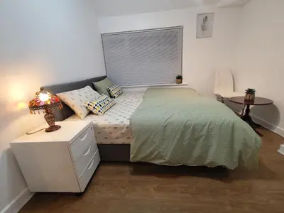 a small bedroom with a bed and a window at Prime Comfort Wigan in Ince-in-Makerfield