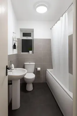 a bathroom with a toilet and a sink and a tub at Prime Comfort Wigan in Ince-in-Makerfield