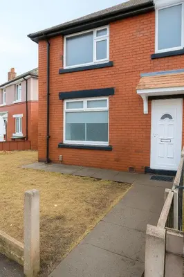 a red brick house with a white door at Prime Comfort Wigan in Ince-in-Makerfield