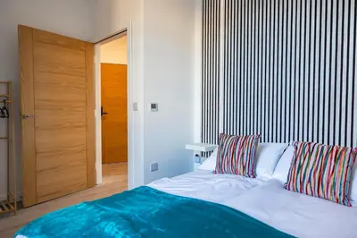 a bedroom with a bed with two pillows on it at Sunbeam House 2 Morecambe Accessible in Morecambe