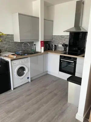 a kitchen with a washing machine and a washer at Sunbeam House 2 Morecambe Accessible in Morecambe