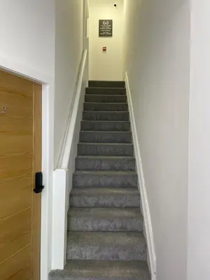 a staircase in a house with grey carpet at Sunbeam House 3 Morecambe in Morecambe