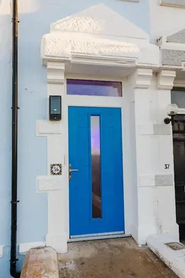 a blue door on the side of a building at Sunbeam House 3 Morecambe in Morecambe