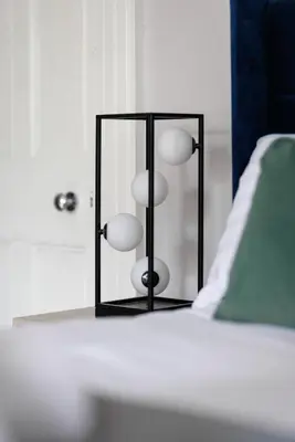 a glass container with balls in it next to a bed at Flatzy - City Centre Mansion, Sleeps 20, 5 Baths in Liverpool