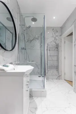 a bathroom with a shower and a sink and a mirror at Flatzy - City Centre Mansion, Sleeps 20, 5 Baths in Liverpool