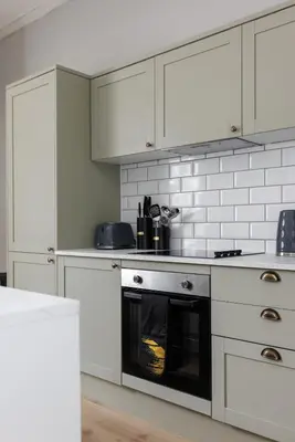 a kitchen with white cabinets and an oven at Flatzy - City Centre Mansion, Sleeps 20, 5 Baths in Liverpool