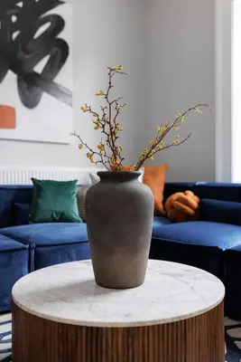 a vase sitting on a table in a living room at Flatzy - City Centre Mansion, Sleeps 20, 5 Baths in Liverpool