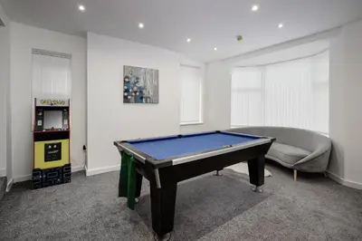a living room with a pool table and a couch at Blackpool Abode - Shaw Heights in Blackpool