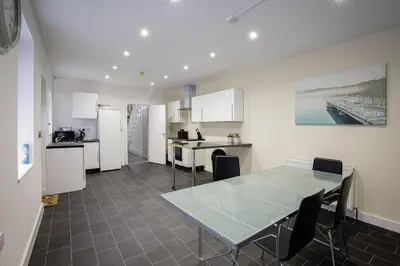 a kitchen and dining room with a table and chairs at Blackpool Abode - Shaw Heights in Blackpool