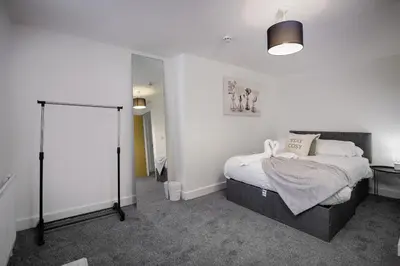 a bedroom with a bed and a large mirror at Blackpool Abode - Shaw Heights in Blackpool