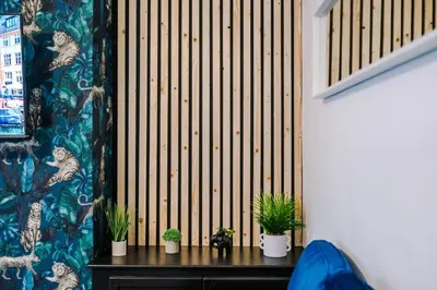 a room with potted plants on a wooden wall at Beautiful Home In Bolton in Bolton