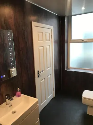a bathroom with a sink and a toilet and a window at Shores Holiday Apartments in Blackpool