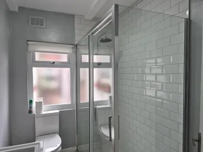 a bathroom with a glass shower with a toilet at House next to Anfield Stadium, Goodison Park in Liverpool