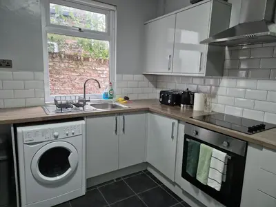 a kitchen with a washing machine and a sink at House next to Anfield Stadium, Goodison Park in Liverpool