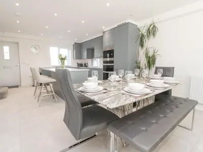 a kitchen and dining room with a table and chairs at Apple Tree Cottage in Preston