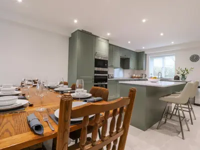a kitchen and dining room with a table and chairs at Pear Tree Cottage in Preston