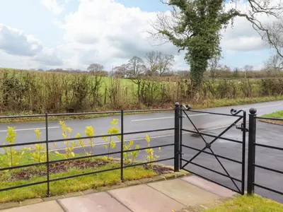 a gate on the side of a road at Pear Tree Cottage in Preston