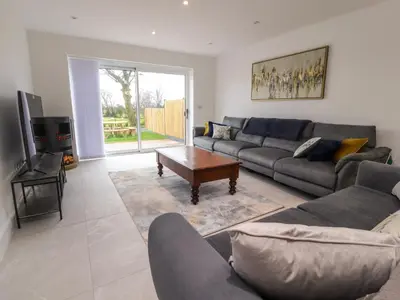 a living room with a couch and a table at Pear Tree Cottage in Preston