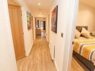 a hallway leading to a bedroom with a bed at 12A Lake Escape in Carnforth
