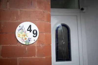 a plate on a brick wall next to a door at Lethbridge Villa 49 3-bedroom Apartment with private HOT TUB,Fibre WiFi, free parking, sleeps 6 in Southport