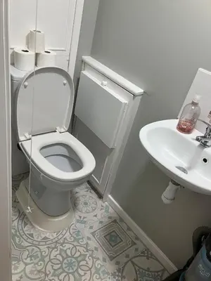 a white bathroom with a toilet and a sink at Stumps and Bails Families and contractors welcome in Ormskirk