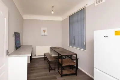 a room with a table and chairs and a window at Spacious Central Liverpool Home in Liverpool