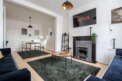 a living room with a couch and a fireplace at LFC Stay 1 Min to Stadium WM Pet Friendly in Liverpool