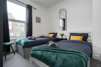 a bedroom with two beds and a window at LFC Stay 1 Min to Stadium WM Pet Friendly in Liverpool