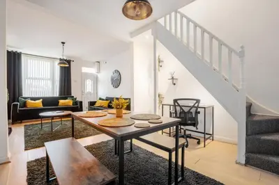 a living room with a table and a couch at LFC Stay 1 Min to Stadium WM Pet Friendly in Liverpool
