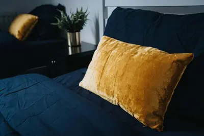 a yellow pillow sitting on a blue couch at LFC Stay 1 Min to Stadium WM Pet Friendly in Liverpool