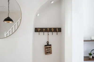 a room with a white wall and a mirror at LFC Stay 1 Min to Stadium WM Pet Friendly in Liverpool
