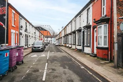 an empty street with cars parked on the side at LFC Stay 1 Min to Stadium WM Pet Friendly in Liverpool