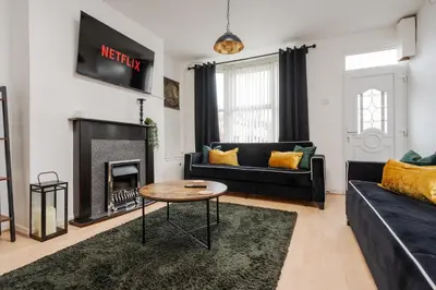 a living room with a couch and a fireplace at LFC Stay 1 Min to Stadium WM Pet Friendly in Liverpool