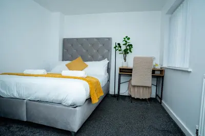 a bedroom with a bed and a desk with a chair at 1 minute walk to Liverpool Stadium Free Private Parking, Anfield Liverpool Entire House in Liverpool