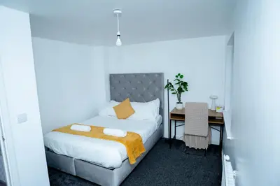 a bedroom with a bed and a desk and a table at 1 minute walk to Liverpool Stadium Free Private Parking, Anfield Liverpool Entire House in Liverpool