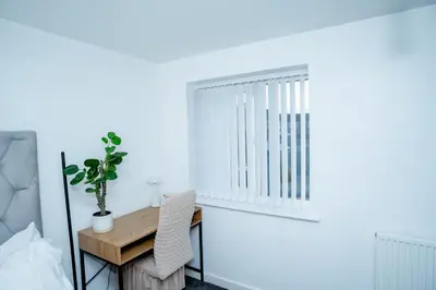 a bedroom with a window and a wooden desk at 1 minute walk to Liverpool Stadium Free Private Parking, Anfield Liverpool Entire House in Liverpool