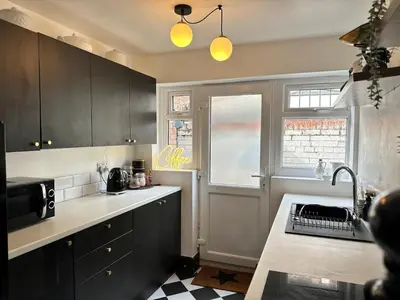a kitchen with black cabinets and a counter top at 1 min to Everton FC Free Parking, Farmhouse Chic in Liverpool