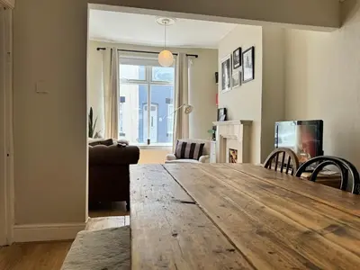 a living room with a large wooden table in a room at 1 min to Everton FC Free Parking, Farmhouse Chic in Liverpool