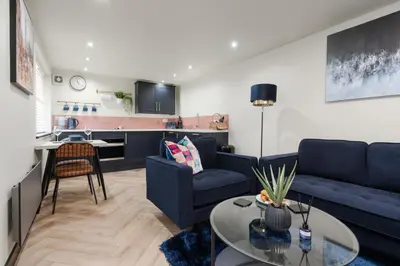 a living room with a couch and a table at The Lodge in Woodplumpton