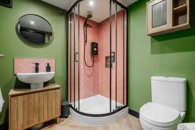 a bathroom with a shower and a toilet and a sink at The Lodge in Woodplumpton