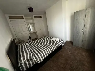 a bedroom with a black and white striped bed at Double bed BW4 Accrington Burnley in Accrington