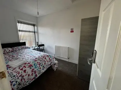 a bedroom with a bed and a window and a door at Double bed BW2 Accrington Burnley in Accrington