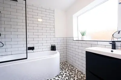 a white bathroom with a tub and a sink at Cosy Home 2 Bedroom House Birkdale in Southport